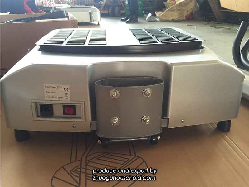 A technician demonstrating the proper way to tighten screws on a vibration platform base.